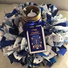 a blue and white wreath with a candle on it