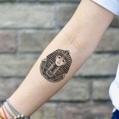 a woman's arm with a tattoo on it that has an image of a cat