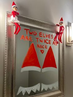 two elfs are sitting on top of a mirror with the words two elves are twice as nice