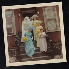 a group of women standing on the steps of a building with flowers in their hands