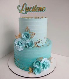 a three tiered cake with blue flowers on top and the name lyclene written above it