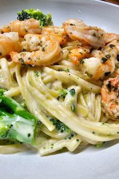 pasta with shrimp and broccoli on a white plate