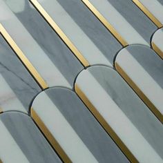 a close up view of some marble tiles with gold and silver trimmings on them