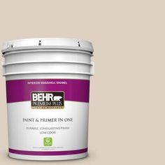 the behr paint and primer in one is shown on a purple background with white trim