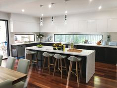 the kitchen is clean and ready to be used for cooking or eating, as well as dining room furniture