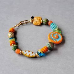 Colorful bohemian style bracelet made by miss.kvartz. Perfect gift for Czech Glass Admirer. This beautiful bracelet in orange and turquoise simply make you happy and remind you of a day at the sea. For this  bracelet I combined a mix of colorful high quality bohemian/czech glass beads. Finished wiht a handmade gold filled hook clasp. You will receive loving and elaborate handwork SIZE : The bracelet has a standard size of 17 cm. You can choose the size of the bracelet from the menu. Thank you! Bohemian Orange Czech Glass Beaded Bracelets, Bohemian Czech Glass Orange Beaded Bracelet, Handmade Multicolor Glass Bracelet, Multi-strand Czech Glass Colorful Beads Jewelry, Czech Glass Bead Bracelet, Czech Glass Jewelry, Colorful Bohemian, Glass Beaded Bracelet, Trending Jewelry