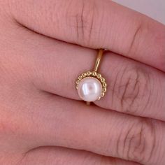 This lovely cultured pearl ring is the perfect gift for a loved one or a great self purchase. The nice size pearl has a gold beading design that is very simple but elegant. The pearl is the most desirable color with a nice white color with rose hues. This ring is a size 6.5 but is sizable. Just let our shop know what size your need and our in house jeweler can take care of that. The details for this beautiful ring are listed below:Metal Quality: 14 K Yellow Gold Gemstone: Freshwater Pearl Gemsto White Akoya Pearl Ring With Pearl Drop, Wedding Pearl Rings With Pearl Pendant, Anniversary Pearl White Rings With Pearl Charm, Anniversary Rings In Pearl White With Pearl Charm, Pearl White Rings With Pearl Charm For Anniversary, Elegant Pearl Chain Ring, Elegant Pearl Drop Ring As Gift, Wedding Pearl White Ring With Pearl Charm, Pearl White Wedding Ring With Pearl Charm