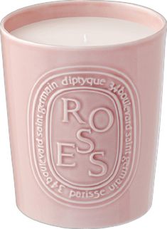 a pink candle with the words roses on it's front and side, in white lettering