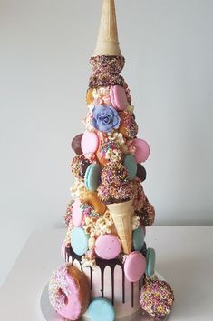 a tower made out of doughnuts and sprinkles