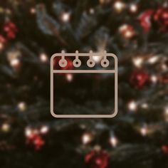 a close up of a christmas tree with lights in the background and an image of a calendar on it