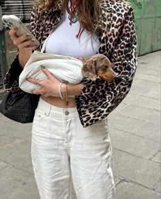 a woman holding a small dog in her arms