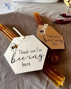 there is a sign that says thank you for being here next to some honey sticks