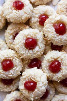 cookies with cherries are arranged on a plate