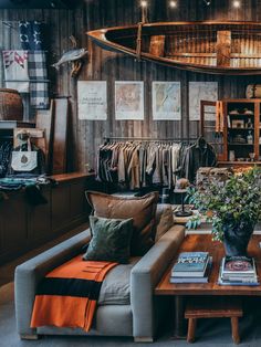 a living room filled with furniture next to a wooden wall