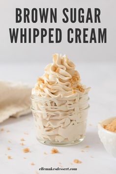 a glass jar filled with whipped cream and topped with cinnamon sprinkles next to a spoon