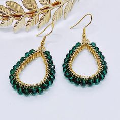 These lovely earrings are handmade using emerald green crystal glass beads. The beads are carefully and individually wrapped around gold teardrop pendants with gold plated, tarnish-resistant wire and hang from hypoallergenic gold 925 sterling silver earring hooks.
The earrings measure approximately 2" long from the top of the earring hook to the bottom teardrop pendant. 
They are perfect to give as a gift or to treat yourself to something special. 
Colors may appear slightly different in images when displayed on your screen. Emerald Green Jewelry, Teal Bracelet, Emerald Green And Gold, Emerald Green Crystal, Earrings Emerald, Rose Gold Beads, Earring Hook, Teardrop Dangle Earrings, Green Jewelry