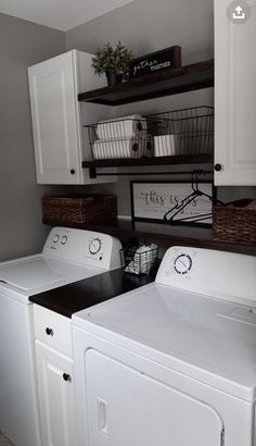 a white washer and dryer sitting next to each other in a laundry room