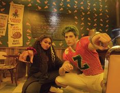 two people sitting on a bench in a restaurant