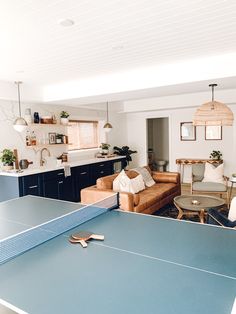 a ping pong table in the middle of a living room