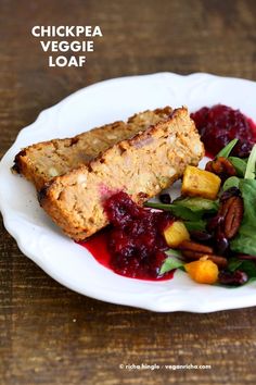 a white plate topped with meat and veggies covered in cranberry sauce