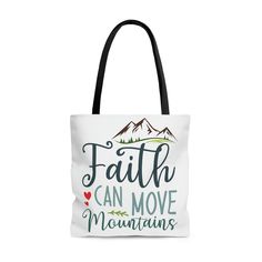 "Looking for a stylish tote bag that can hold all your essentials and make a statement of faith? Look no further than the \"Mountain Movers\" tote bag. Featuring bold, colorful text that says \"Faith can move mountains\" with a scenic mountain landscape, this bag is the perfect way to carry your faith with you wherever you go. Crafted from high-quality materials, this tote bag is built to last. Made from 100% polyester, it features boxed corners for added durability and black inner stitching with transparent thread on hems for a sleek, modern look. The black cotton handles make it easy to carry, while the non-woven laminate inside provides added protection for your belongings. Plus, with a size tolerance of 0.75 inches, this bag is perfectly sized to accommodate all your essentials. Whethe Christian Tote Bags, Faith Can Move Mountains, Stylish Tote Bag, Move Mountains, Christian Women, Mountain Landscape, Christian Gifts, Running Errands, Black Cotton