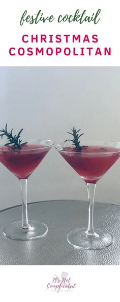 two martinis with rosemary garnish sit on a silver table and text reads festive cocktail christmas cosmopolian