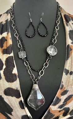 "Artisan Zen Hand Forged Faceted Crystal chandelier Southwestern Pendant with Rolo gunmetal chain and black faceted onyx gemstone with earrings handmade boho set. Beautiful handmade soldered chandelier faceted dangle measures 58mm x 36mm and hangs from a big oval Rolo gunmetal organic chain circle links measuring 10mm x 14mm.   The chain measures 25\" and can be adjusted.  The second row is made of 3mm faceted black onyx gemstone beads and measures 24\".  There are two accent faceted clear cryst Silver Hematite Jewelry With Black Beads, Black Bohemian Jewelry With Faceted Beads, Black Teardrop Bohemian Jewelry, Black Metal Teardrop Necklace, Black Teardrop Metal Necklace, Black Faceted Teardrop Jewelry, Black Teardrop Pendant For Jewelry Making, Black Faceted Beads Dangle Jewelry, Bohemian Silver Jewelry With Hematite