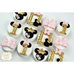 mickey mouse cupcake toppers with pink bows and gold trimmings on them