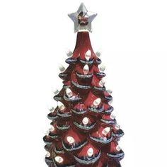 a red glass christmas tree with lights on it