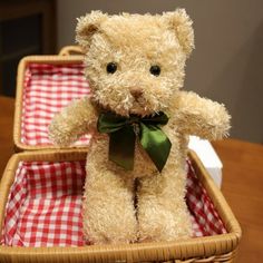 a teddy bear sitting in a basket on a table