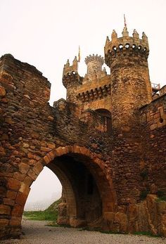 an old stone castle with two towers and gates