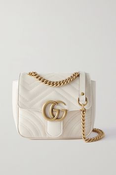 Gucci's 'GG Marmont' collection continues to grow with the addition of this compact shoulder bag. Made from matelassé leather featuring the brand's recognizable zigzag quilting, it's embellished with a gold-tone logo at the front flap and has an adjustable chain-trimmed strap that can be worn cross-body or doubled up. Gucci Soft Leather Shoulder Bag, Designer Gucci Shoulder Bag In Soft Leather, Designer Gucci Soft Leather Shoulder Bag, Gucci Luxury Soft Leather Shoulder Bag, Gucci Soft Leather Crossbody Shoulder Bag, Gucci Soft Leather Crossbody Bag, Luxury Gucci Shoulder Bag In Soft Leather, Luxury Gucci Soft Leather Shoulder Bag, Luxury Gucci Soft Leather Bag