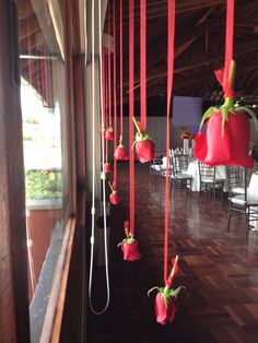 red flowers hanging from the ceiling in a restaurant