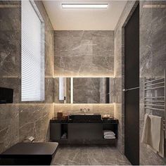 a bathroom with grey marble walls and floor