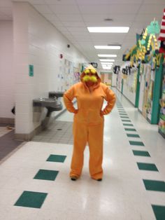 a man in an orange suit is standing on the floor