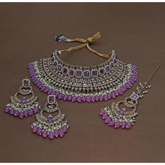 Description: Enhance your elegance with this stunning Traditional Indian Kundan Necklace Set featuring matching earrings, meticulously crafted to perfection. This exquisite jewelry set is the epitome of luxury, blending traditional design with contemporary flair, making it a must-have for every jewelry collection. Product Features: Material: High-quality Kundan stones, gold-plated alloy, and pearl detailing. Design: Intricately designed with a beautiful combination of beads that add a pop of col Kundan Necklace Set, Kundan Necklace, Bollywood Jewelry, Purple Jewelry, Kundan Necklaces, Indian Bollywood, Kundan Jewellery, Pearl Choker, Traditional Indian