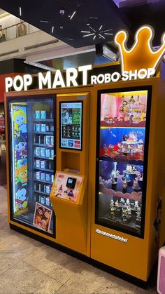 an orange toy vending machine sitting in front of a sign that says pop mart rob shop