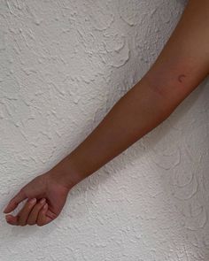 a person's arm with a small tattoo on the left side of their arm