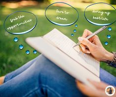 a person writing on a notebook with bubbles above them