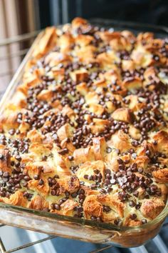 a casserole dish with chocolate chips and nuts in it on a cooling rack