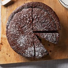 a chocolate cake on a wooden cutting board