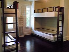 there are bunk beds in the room with wooden floors