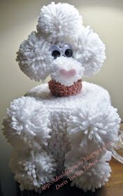 a white stuffed animal sitting on top of a wooden table