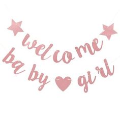 pink welcome baby banner with hearts and stars hanging from the side, on a white background