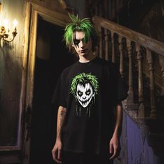 Stand out this Halloween with this edgy neon green-haired skull graphic T-shirt. Perfect for anyone looking to add a spooky touch to their wardrobe, this shirt features a bold, horror-inspired design that's both eerie and stylish. Made from soft, breathable cotton, it's not only perfect for Halloween parties but also comfortable enough for everyday wear. Get ready to turn heads with this unique and eye-catching tee! Graffiti Print T-shirt For Halloween Streetwear, Edgy Halloween T-shirt For Alternative Fashion, Edgy Halloween T-shirt With Screen Print, Edgy Halloween Streetwear T-shirt, Punk T-shirt For Halloween Streetwear, Punk Style Halloween T-shirt For Streetwear, Punk Style T-shirt For Halloween Streetwear, Emo Halloween T-shirt With Short Sleeves, Edgy Halloween Concert T-shirt