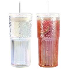 two glasses with strawberries in them sitting next to each other on a white background