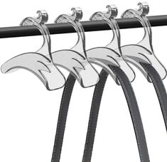 three black and white leashs hanging from a rack with two hooks on each side