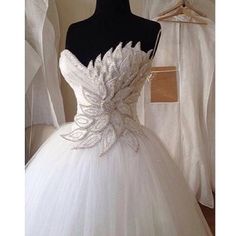 a white wedding dress on a mannequin