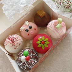 a box filled with different types of donuts