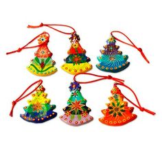 six colorful ornaments hanging from red string on a white background, each decorated with an ornament shaped like a christmas tree